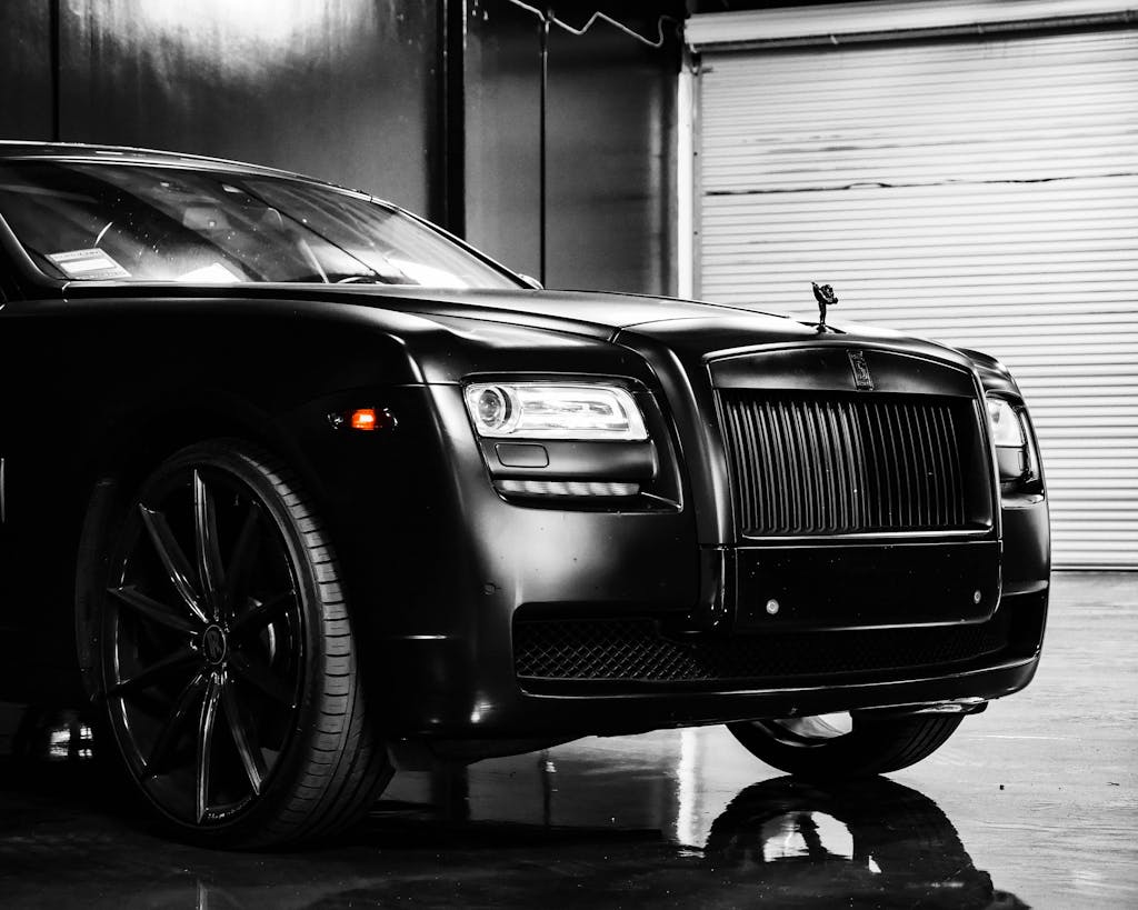 Hood of elegant luxury black car parked on marble floor in modern building garage